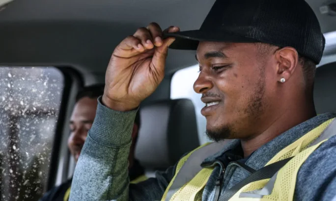 Commercial truck driver in cab during winter weather, highlighting the safety risks of breakdowns and the need for emergency supplies and preparedness.