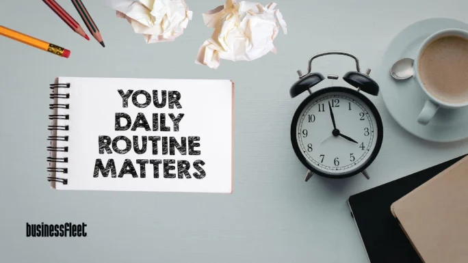Notebook reading “Your Daily Routine Matters” beside a clock and coffee, representing how consistent safety routines and habits help small fleet teams reduce risk and improve operations.