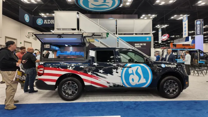 Adrian upfit pickup truck with cargo storage system on display at Work Truck Week 2026 demonstrating modular pickup work truck solutions.