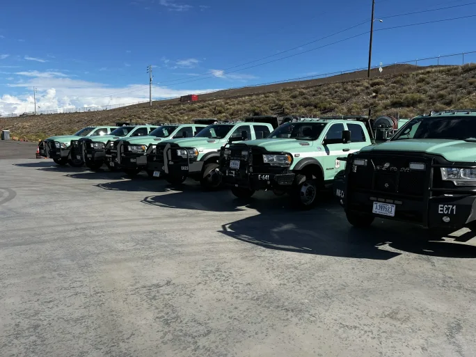 Row of green fleet trucks lined up, representing fleet capacity and the challenge of maintaining readiness during emergencies