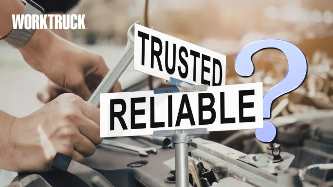 Mechanic working under the hood of a truck with “Trusted” and “Reliable?” signs, highlighting what makes fleet vehicles dependable