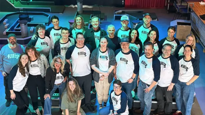 Group photo of Fillip Fleet employees wearing company-branded shirts during a team gathering at the company's Calgary headquarters.