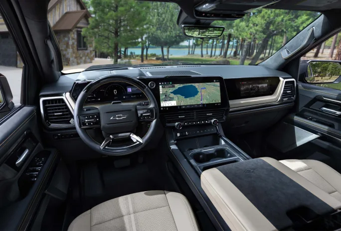 Interior view of the 2027 Chevrolet Silverado 1500 showing the digital instrument cluster, center touchscreen, passenger display, and center console.