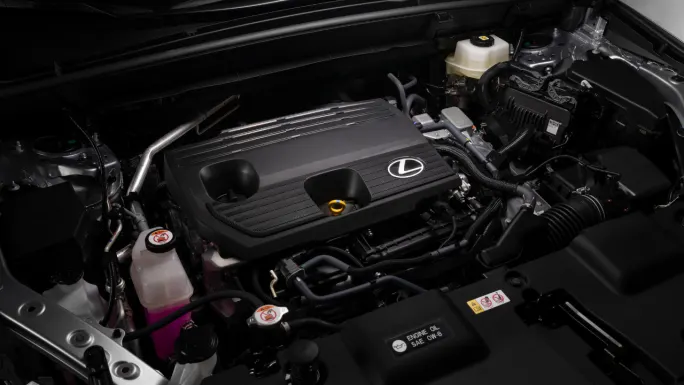 Engine compartment of the 2027 Lexus NX showing the Lexus hybrid powertrain and surrounding components.