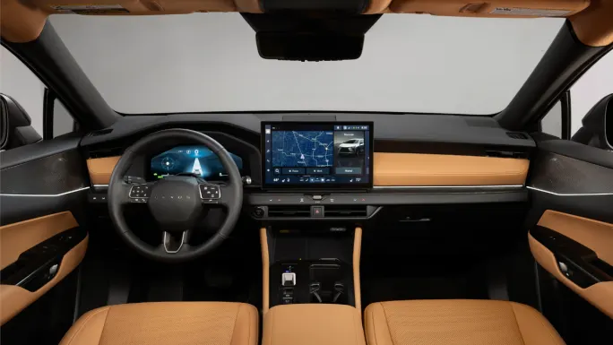 Interior of the 2027 Lexus NX showing the steering wheel, digital instrument cluster, 14-inch center touchscreen, and two-tone cabin.
