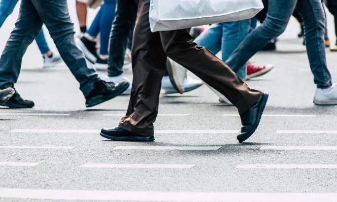 People are walking across a crosswalk.
