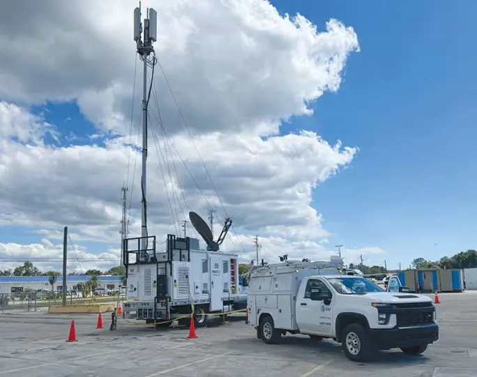 Portable cell tower deployed in a disaster area to restore emergency communication services