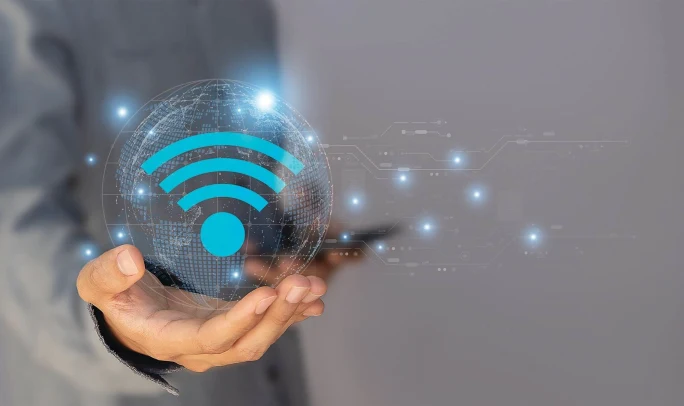 Person holding a digital representation of a wireless signal icon, symbolizing wireless connectivity, real-time data transmission, and cloud-based fleet communication systems.