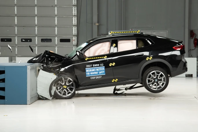 A black IIHS vehicle is totaled at a test site