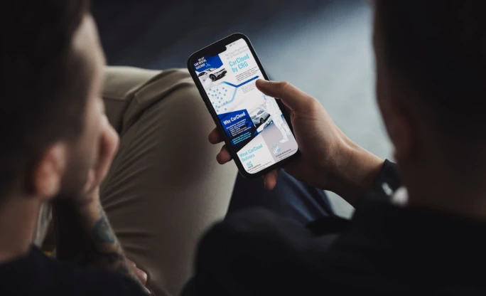 Two people looking at a smartphone screen.