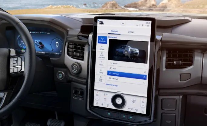 Pickup truck dashboard with a vertical iPad style computer screen showing telematics data.