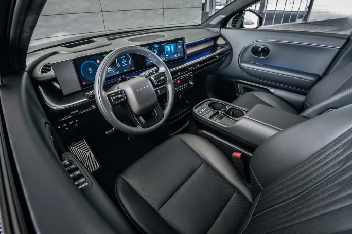 Interior of Hyundai IONIQ 9 showing dashboard, steering wheel, digital displays, and black leather seating.