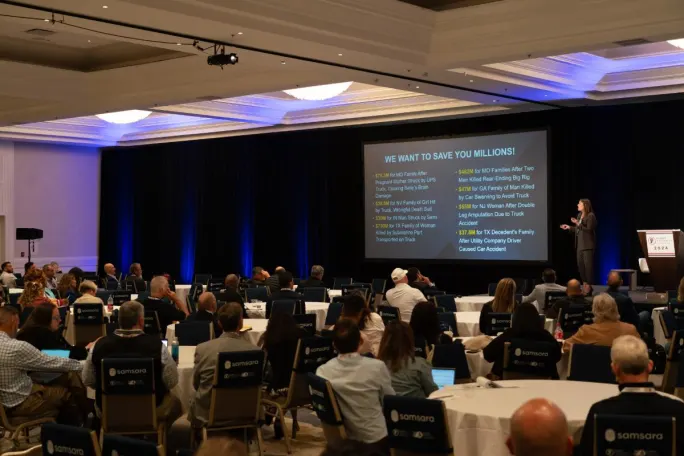 Wide shot of attendees watching keynote address.
