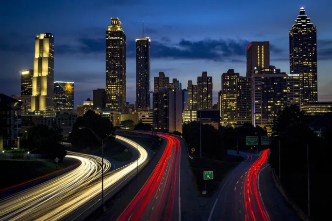 Time lapse photo of cars driving on highway with light trails.
