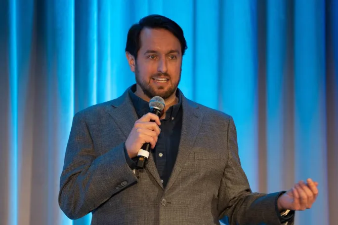 Christopher Schnese makes a point on stage.