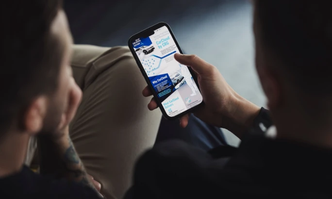 Two people looking at a smartphone screen.