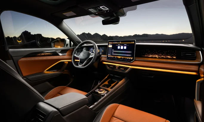 A 2025 Volkswagen Tiguan interior view of the front cabin space with Atmosphere lighting.