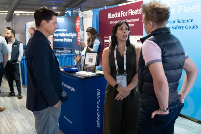 Attendees mix with exhibitors on show floor.