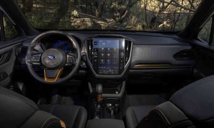 2026 Subaru Forester Wilderness front-cabin interior featuring front dashboard and drivers/passenger seats.