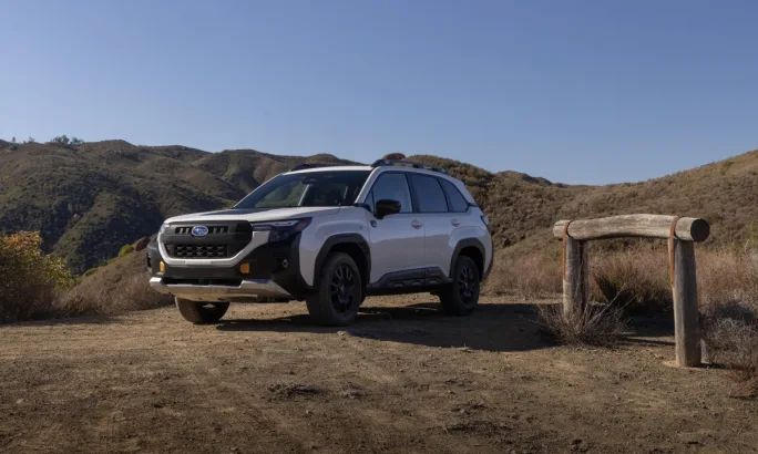 A white 2026 Subaru Forester Wilderness parked in front of hills.