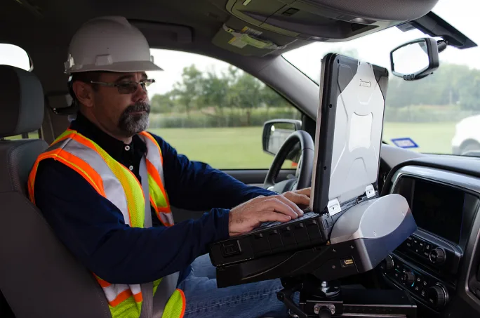 Driver in a truck cab on a rugged tablet