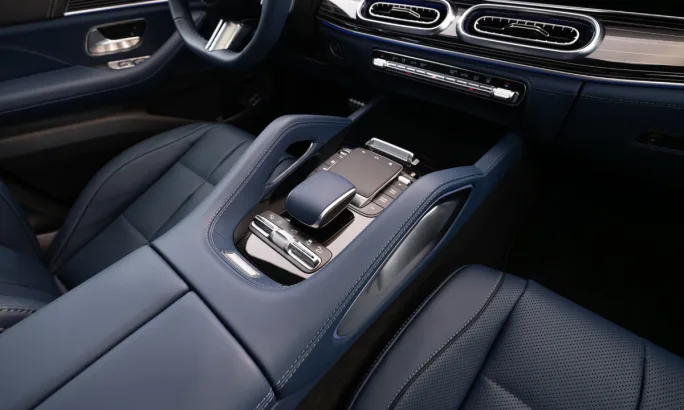 Close-up of Mercedes-Benz GLE center console with touch controls, leather trim, and modern infotainment interface.