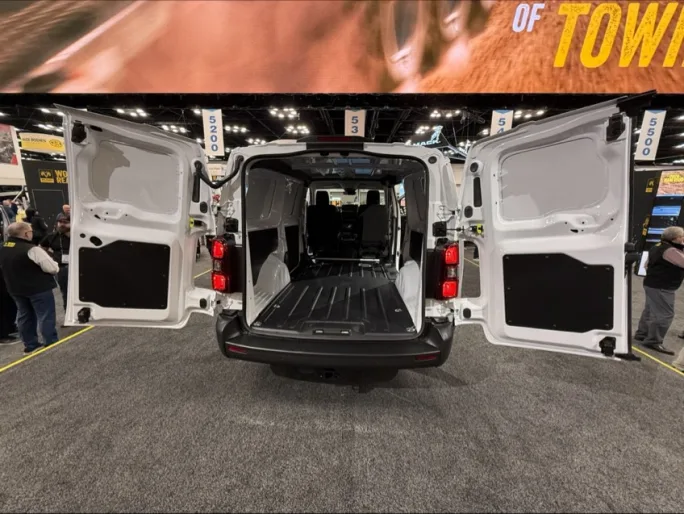Rear view of the 2027 Ram ProMaster City cargo van with both rear doors open at Work Truck Week 2026, showing the compact commercial van’s cargo space and loading area.