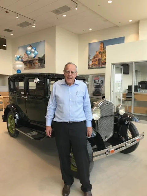 Jim Press w/ a Model A Ford at a local Ford dealership.