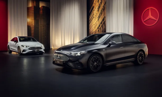 Two 2026 Mercedes CLA sedans in a showroom.