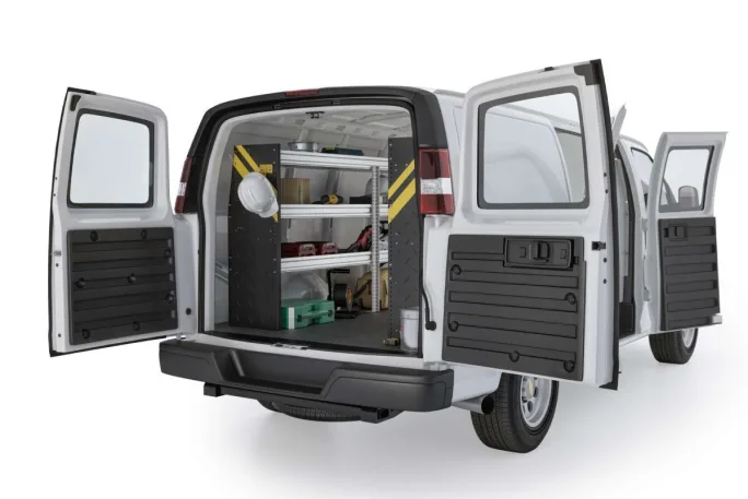 A white work van on a white background upfitted with vocational-specific storage in the cargo area.