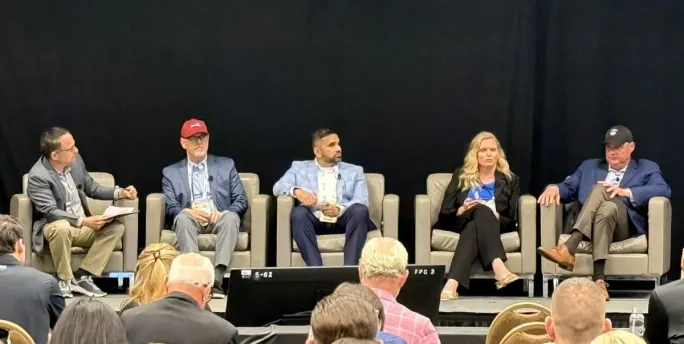 Photo of panelists on stage.