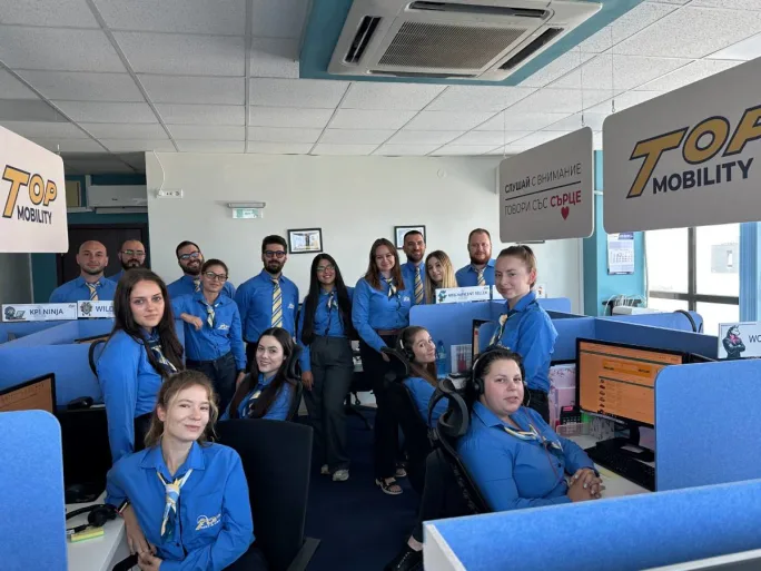 Top Rent A Car's customer service team in blue company shirts.