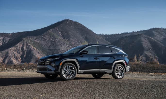 Hyundai Tucson Hybrid SUV parked on a mountain road, recognized as Best Compact Hybrid SUV for its efficiency, performance, and value in U.S. News rankings.