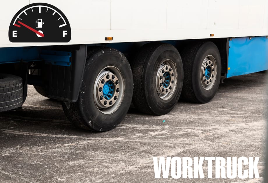 Big rig tires close up with a fuel economy gauge