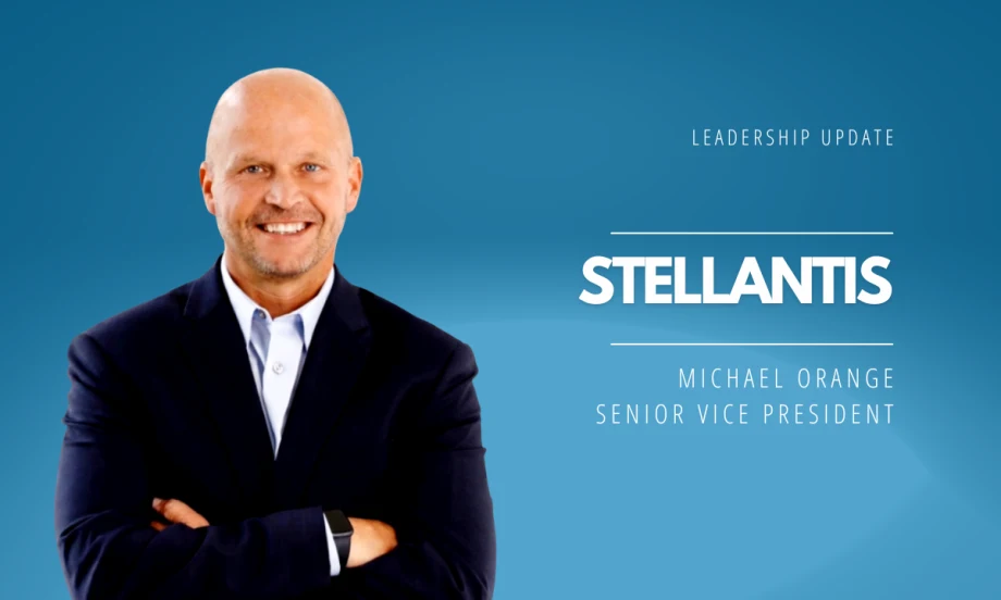 Portrait of Michael Orange in a suit with arms crossed against a blue background, announcing his appointment as Stellantis Senior Vice President leading U.S. sales and network performance.