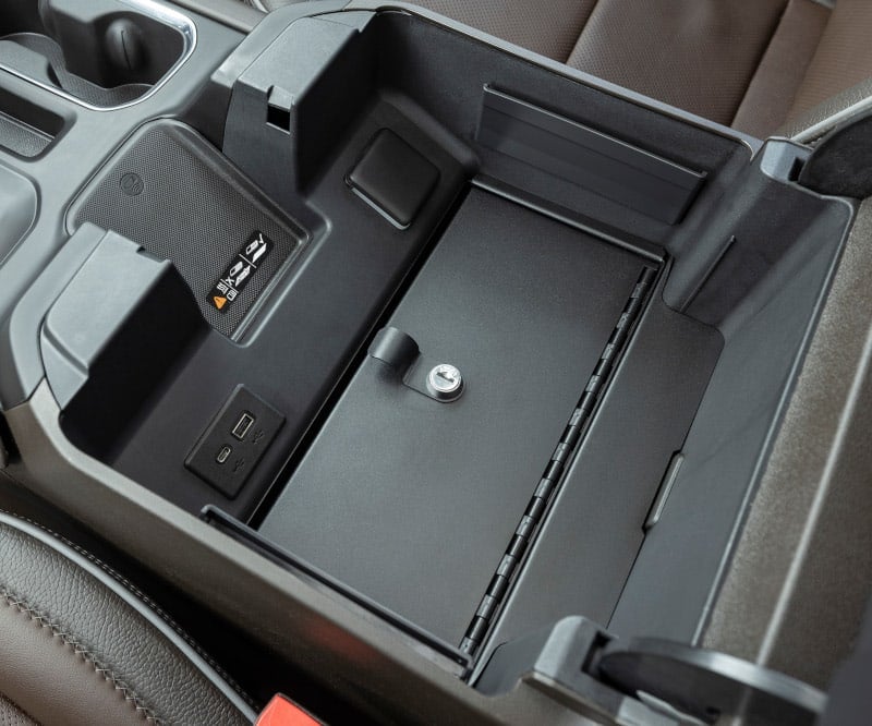 Security safe installed in the center console of a pickup truck.
