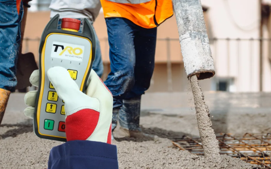 Photo of a remote control controlling the flow of concrete on a job site.