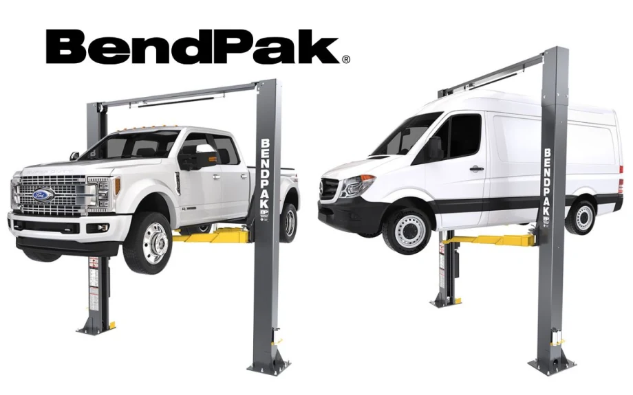 A white pickup truck and a white van each on an automotive lift.