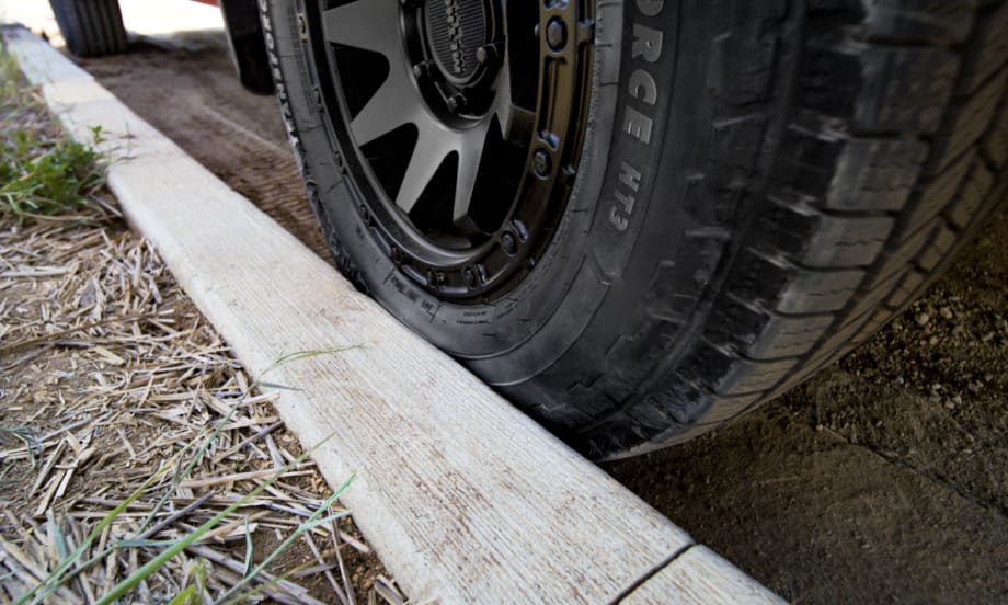 Truck tire scrubbing against a curb.