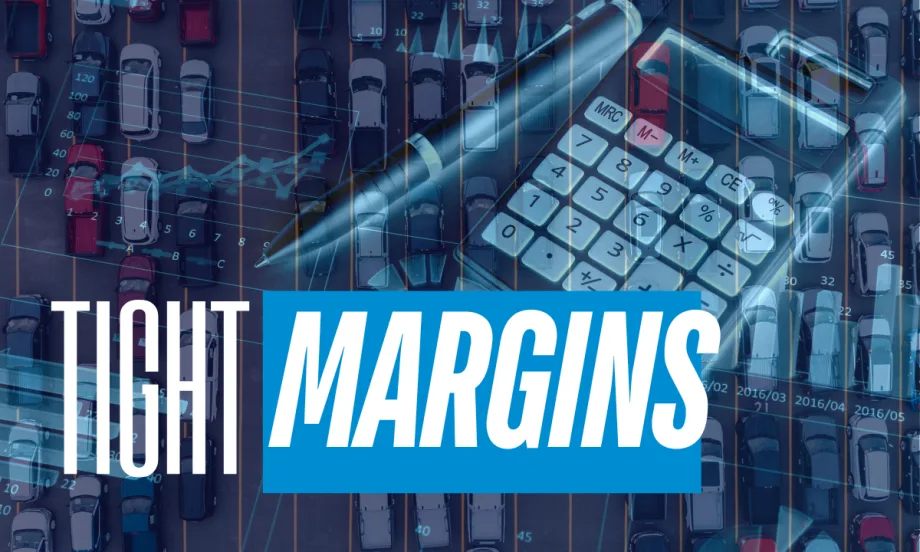 Aerial view of a crowded parking lot with financial graphics, calculator, and pen overlayed, illustrating tight fleet margins and cost pressure.