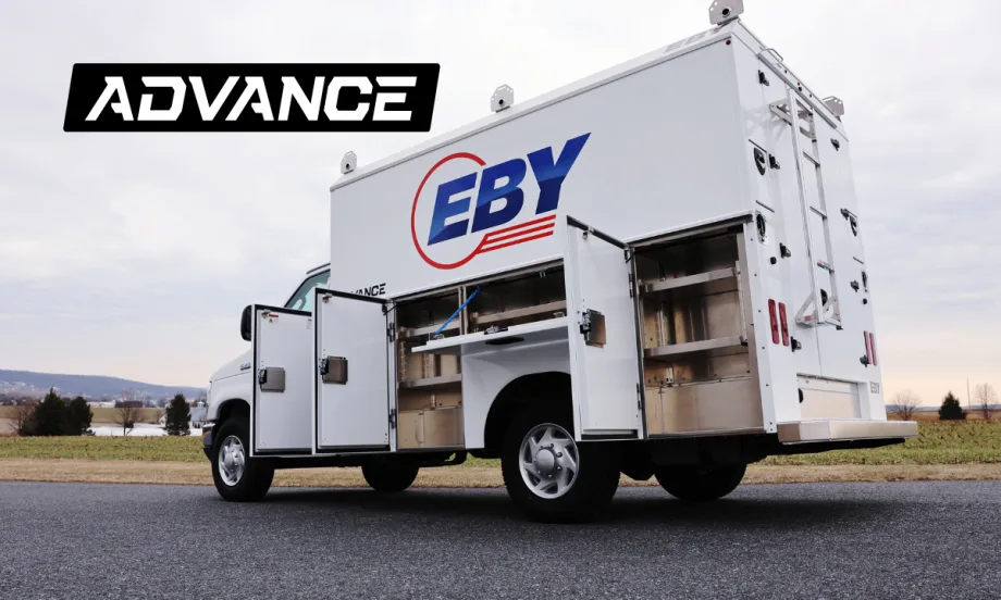 quarter-side rear view of a white service truck with cabinet doors open.