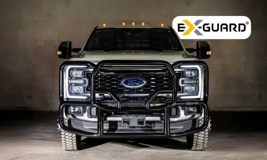 Front view of a Ford Heavy Duty pickup with a black grille guard and logo for Ex-Guard.