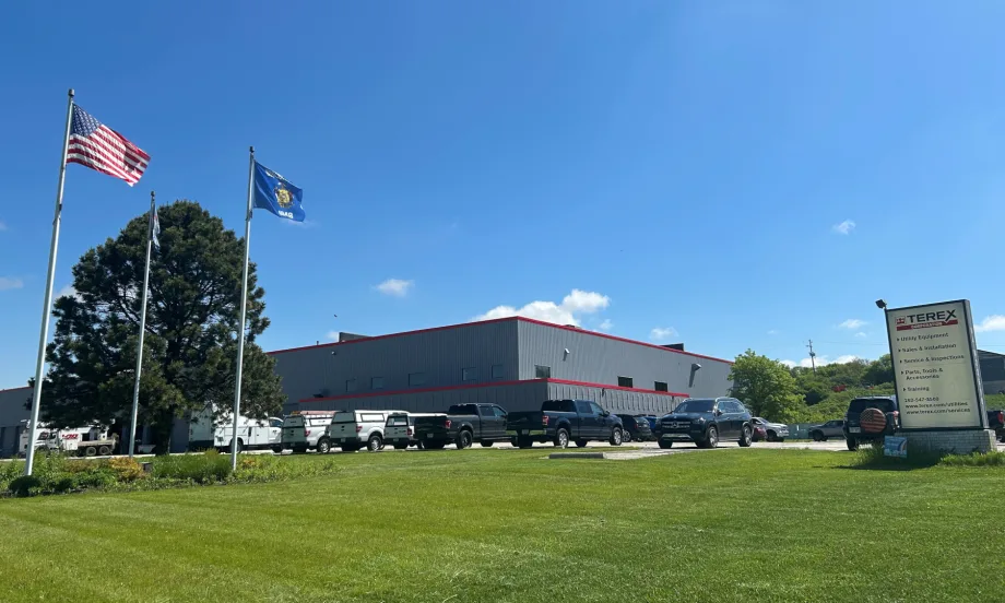 External photo of an industrial building against a blue sky.