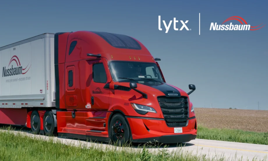 Red tractor trailer driving on a road, inset company logos for Lytx and Nussbaum.