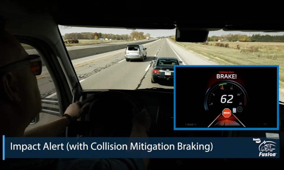 View from a truck cab showing Bendix Fusion collision alert on a dashboard display with a warning to brake at 62 mph.