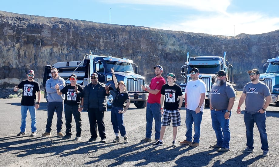 Group of vocational truck drivers and ATS gamers standing in front of Western Star trucks at the 2025 Star Nation Experience in Madras, Oregon.