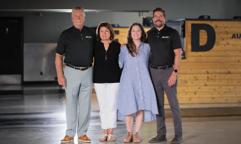 The Boswell family stands together inside Missouri Auto Auction, marking the company’s 25th anniversary.