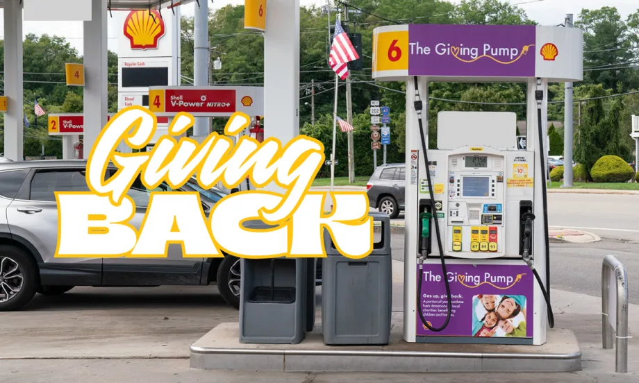 A Shell station featuring a purple Giving Pump where a portion of fuel sales is donated to local charities supporting children and families.