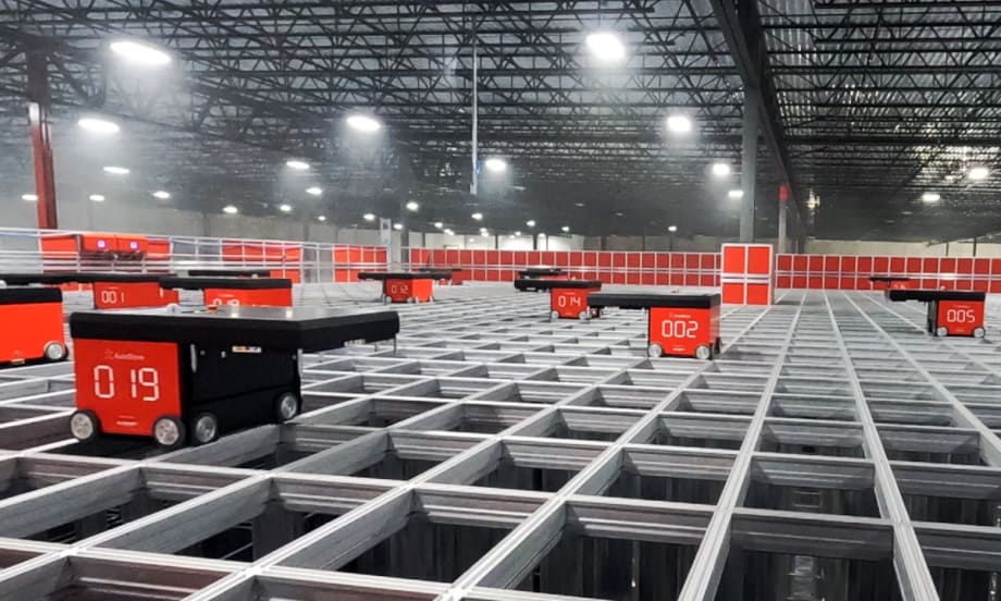 Robotic order pickers navigate on top of a grid.