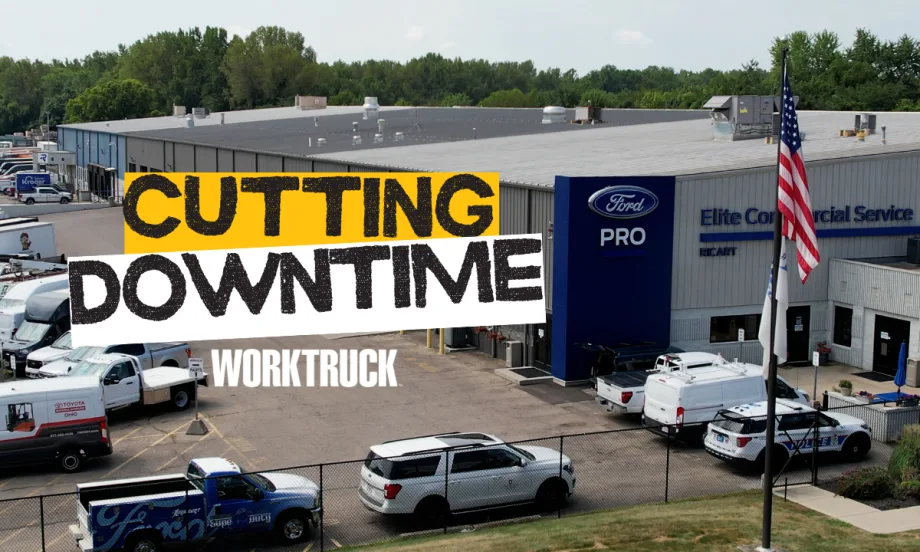 Exterior of Ford Pro Elite Commercial Service Center with Cutting Downtime sign and work trucks outside.